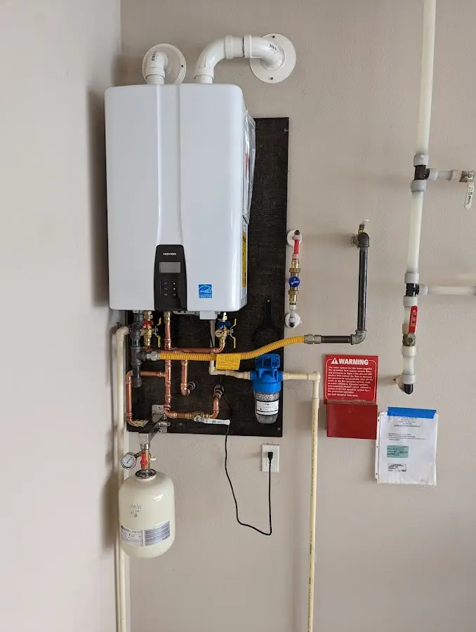 Professional plumber installing copper piping in a Harrisburg home